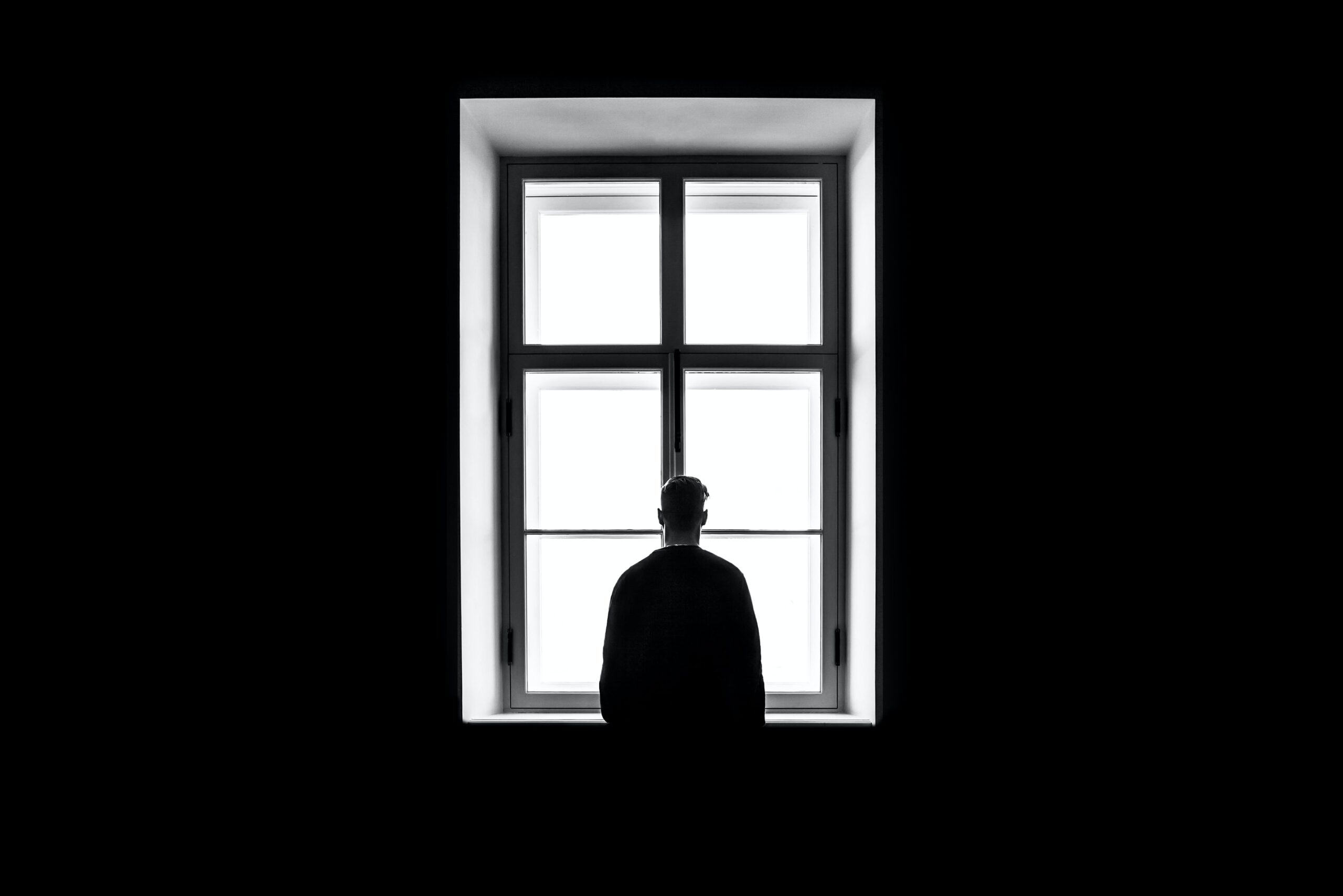 Man standing in front of window